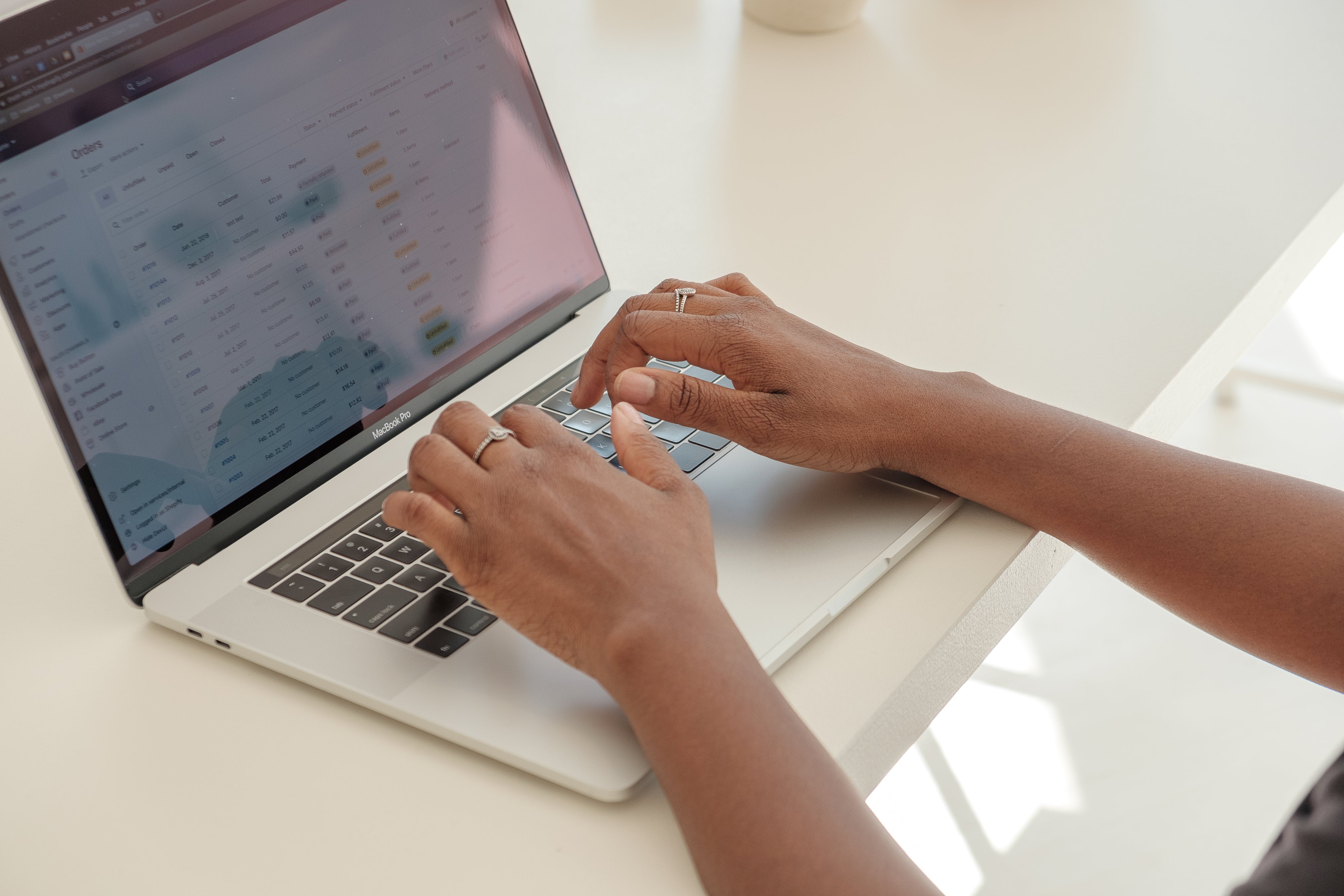 store-owners-hands-typing-away